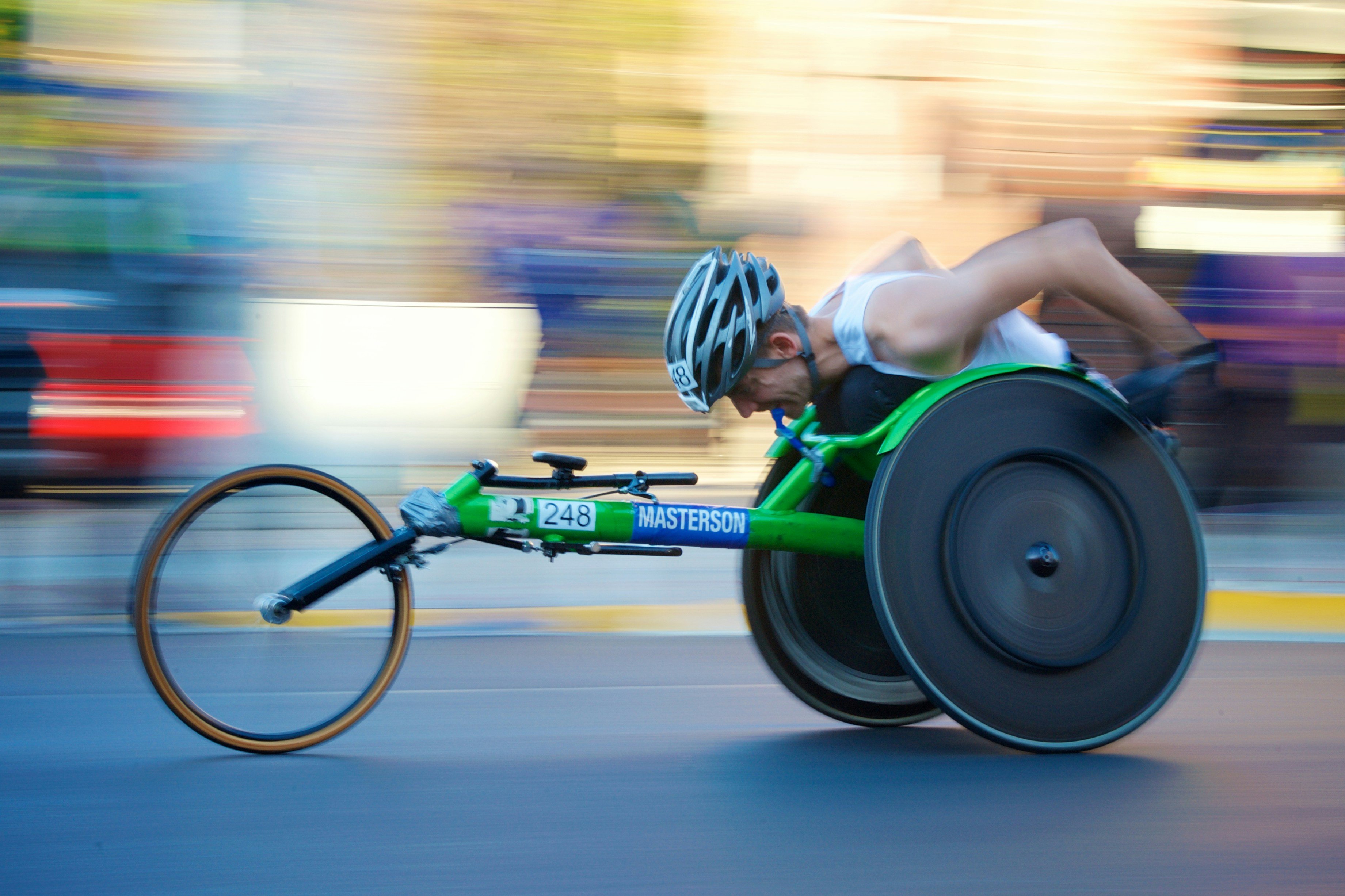 Paralympic athlete racing on a three-wheeled bike